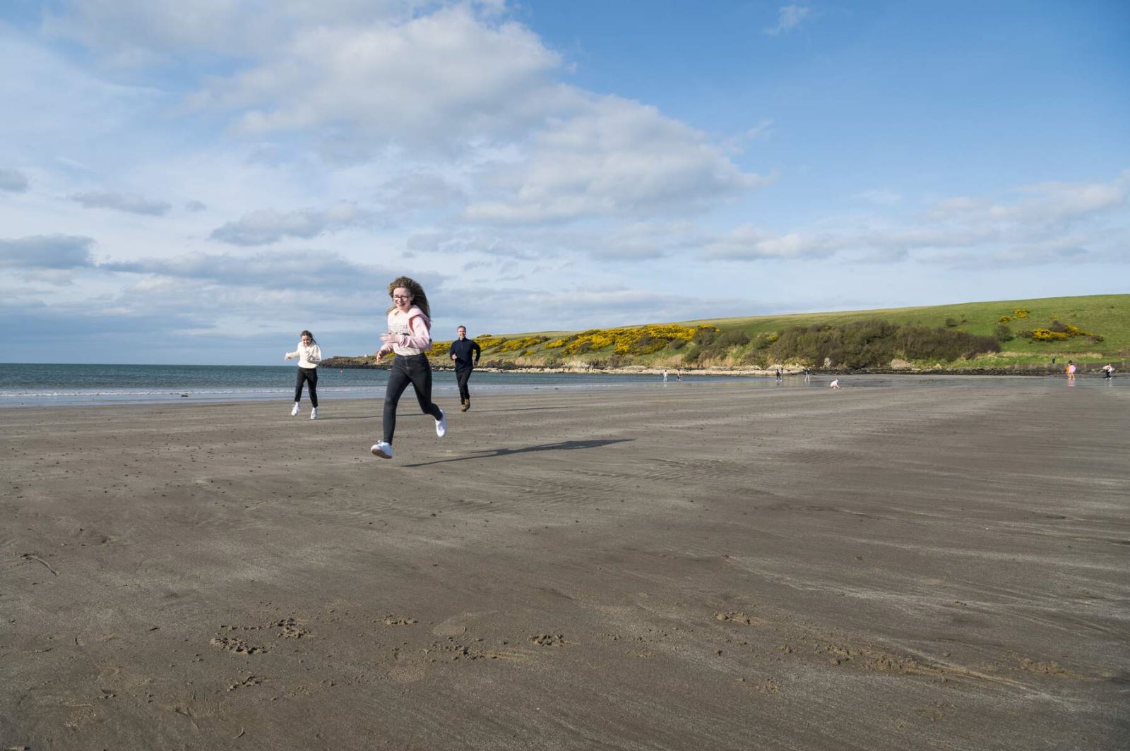 Kids running on the beach at Brown's Bay